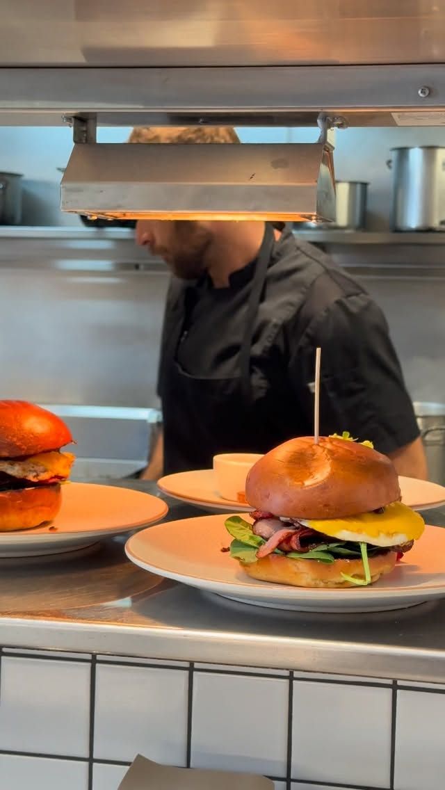 Stable cheeseburgers coming off the pass